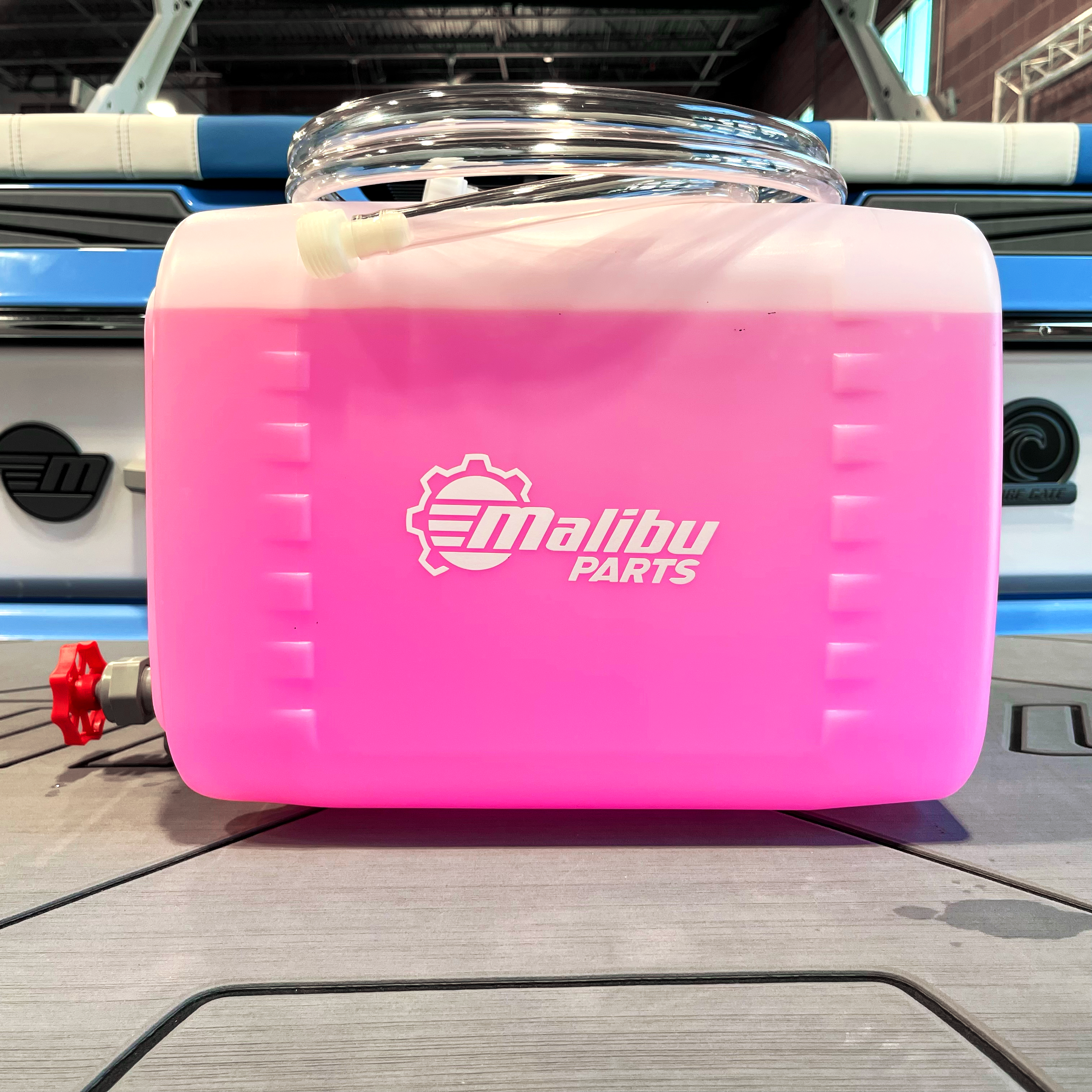 Pink Malibu Parts 5-gallon winterize kit with hoses and a drain valve, designed for winterizing boats and equipment.