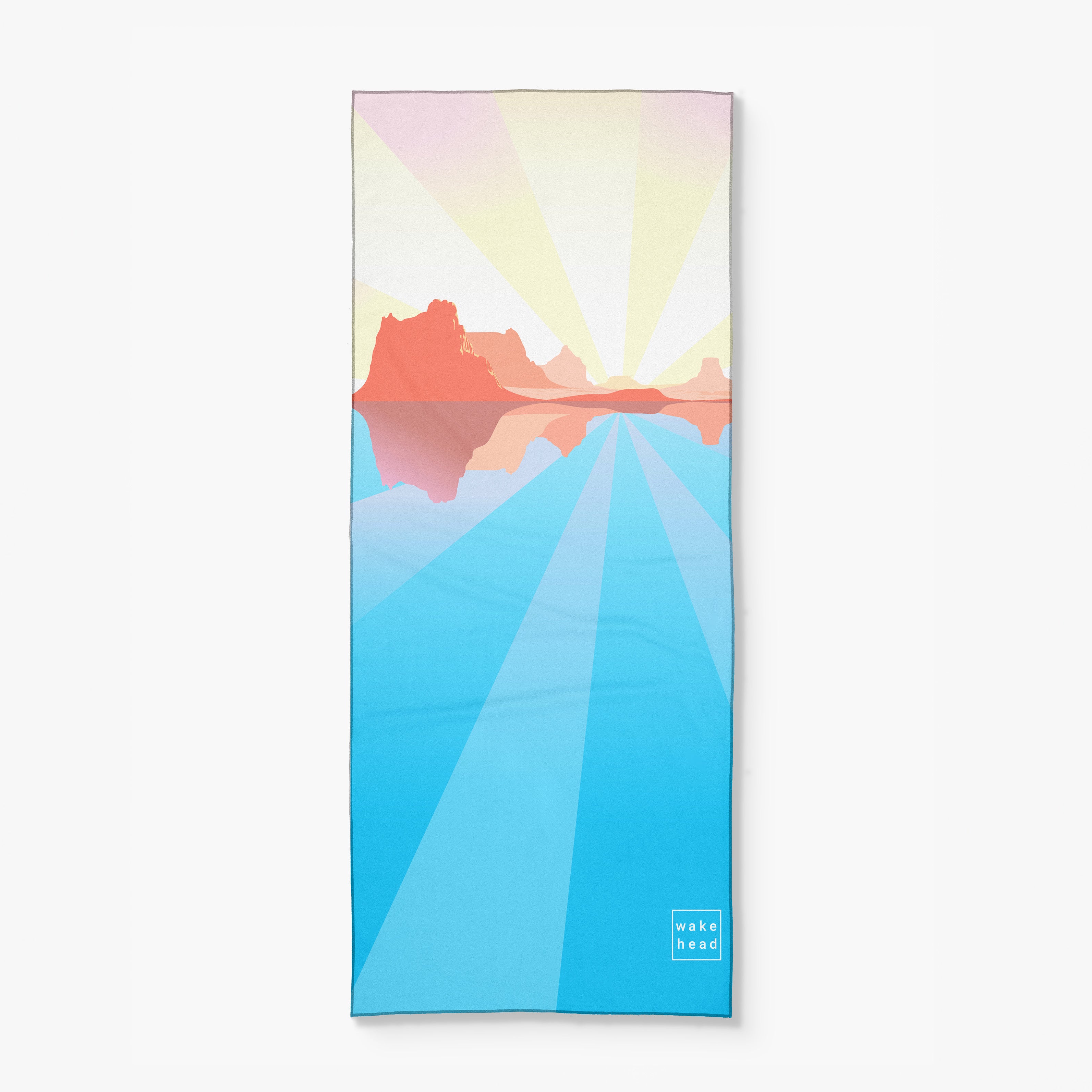Colorful desert landscape illustration on a yoga mat with "Wake Head - Desert Rays" branding in the corner.