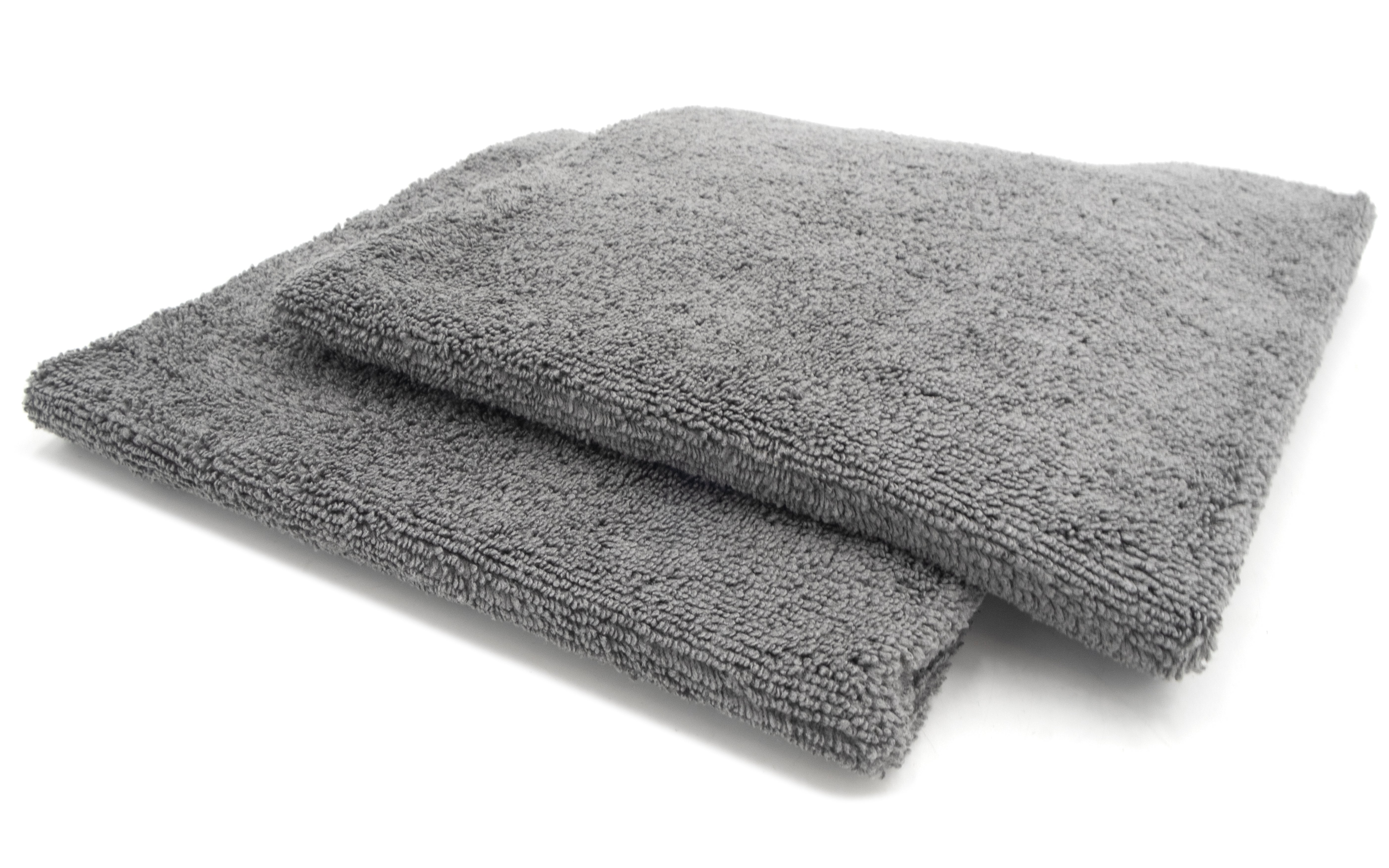 Two gray edgeless microfiber towels stacked, soft, absorbent, and ideal for cleaning or drying.